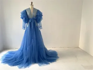Blue tulle robe detail, sheer fabric, tiered ruffles sleeves, long flowing bridal train.
