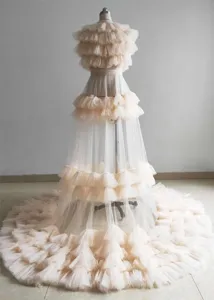 Stunning tiered mesh long train dress details, champagne ruffle evening gown texture view.