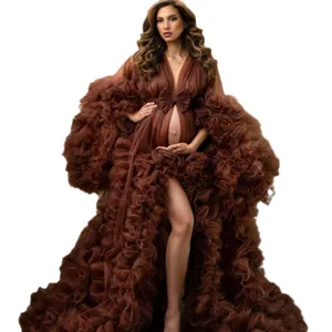 Stunning brown maternity tulle dress with dramatic ruffles and bow, perfect for photo shoots.