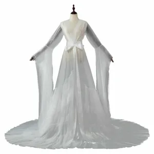 Exquisite long tulle sleeves and dramatic train detail of the elegant sheer mesh dress.