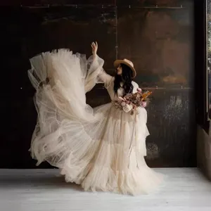 Elegant multi-layer tulle maternity dress and wedding gown, perfect for photography and events.