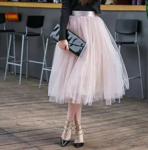 Detailed view of women pink tulle pleated skirt, high waist mesh midi skirt styling detail.