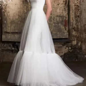 White tiered tulle skirt detail shot, high waist sheer layered maxi skirt fabric and drape.