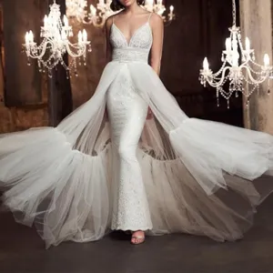 Stunning white lace mermaid wedding dress with layered tulle overskirt and dramatic train.