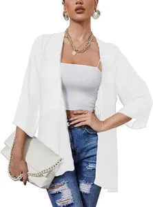 Detailed view of the sheer chiffon sun protection cardigan styled with a white camisole.