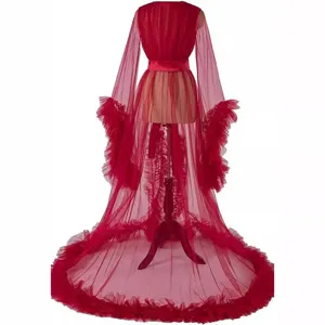 Red sheer tulle robe with dramatic ruffle sleeves and long train for bridal photography and events.