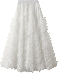 Detail view of a white multi-layered tulle cake skirt featuring fluffy ruffles and elastic waistband.