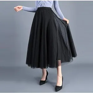 Close-up detail of the elegant black layered mesh long skirt in motion, airy and graceful.