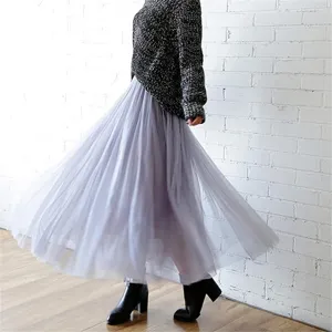 Soft grey pleated tulle midi skirt detail showing multi-layered mesh and flowing silhouette.