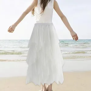 Vue détaillée de la jupe longue en tulle blanc avec tissu léger pour look de plage chic.