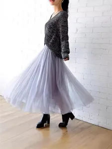 Elegant women's pleated tulle midi skirt, fluffy mesh layer for spring and summer fashion look.