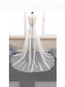 Detail view of the white double-layer mesh train skirt displayed elegantly on a mannequin.