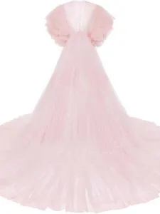 Detail shot of the pink tulle puffy dress, featuring layered mesh and long train for photos.