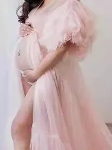 Pink maternity tulle dress with long tail and fluffy sleeves, elegant pregnancy photo gown.