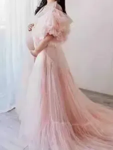 Pink tulle maternity dress detail shot, featuring fluffy tiered ruffles and long train.