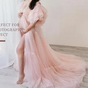 Pink tulle maternity dress with long train and puffy sleeves for photography. Elegant gown.