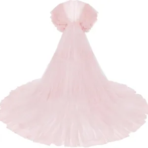 Pink tulle maternity dress with dramatic puffy sleeves and long train for photography studio.