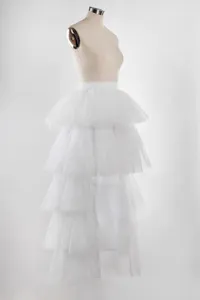 White layered tulle mesh midi skirt detail, elegant tiered tutu skirt texture and fluffy design.
