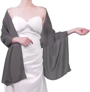 Detail view of a dark grey chiffon shawl draped on a model, lightweight bridal accessory.