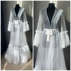 Sheer white mesh fabric with scattered pearls details view for bridal robes unique design.