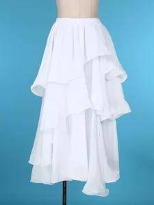 Close-up detail of white layered ruffle dance skirt showcasing fabric texture and flow design.