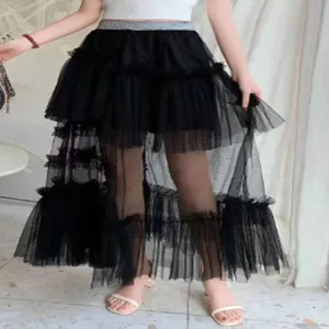 Detailed view of the stylish black layered mesh skirt, showing irregular ruffles and tiers.