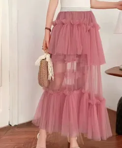 Detailed view of women's pink layered mesh cake skirt, featuring irregular tulle tiers.