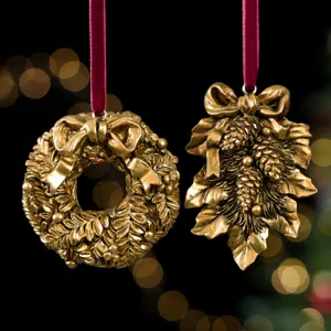 Close-up detail of gold vintage Christmas resin hanging ornaments with red ribbons and festive decor.