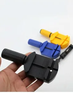Close-up detail of the watch strap link remover tool, highlighting the metal pin and handle.