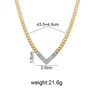 Detail view of the two-tone geometric V-shaped paved diamond pendant on a stylish gold curb chain.