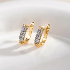 Close-up of geometric pave rhinestone gold huggie earrings detailed shot view showcase