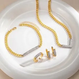 Close-up detail of luxury two-tone geometric rhinestone jewelry set with curb chain.