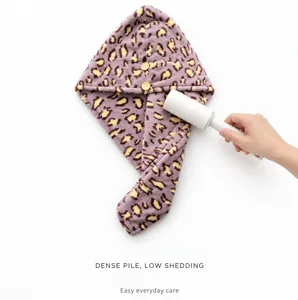 Microfiber leopard print dry hair cap with thick absorbent material for quick drying long hair.