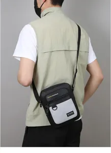 Detailed shot of a stylish men's black and grey crossbody shoulder bag with zipper pockets.