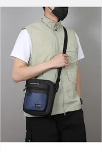 Detailed shot of men stylish cross-body bag worn by model, showing casual design and pockets.