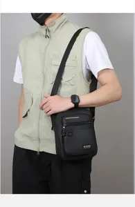 Detailed view of the men's casual crossbody bag, stylish black canvas shoulder bag for daily use.