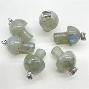 Close-up of natural crystal stone mini mushroom pendants with silver bails, perfect for DIY.