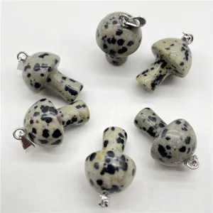 Closeup of natural stone crystal mushroom pendant with silver loop for DIY jewelry making accessories.