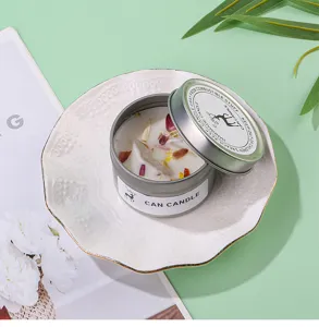 Scented candle in tin can with dried flowers and crystal stones, home fragrance decor item