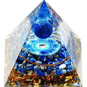 Handmade crystal pyramid ornament with gemstone chips and copper coil for home table decor.