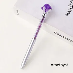 Creative raw crystal gemstone metal ballpoint pen detail view showing purple stone top.