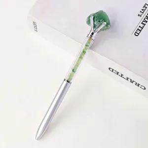 Natural crystal stone metal ballpoint pen detail view, elegant office stationery tool.