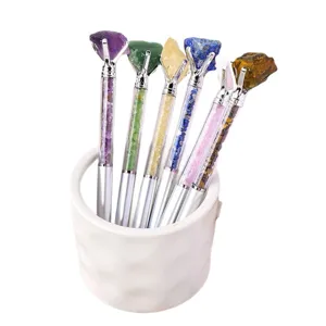 Natural crystal raw stone ballpoint pens set with gemstone chip fill and pen holder.