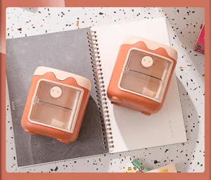 Detail shot of cute cartoon pig desktop organizer with clear door and multi-grid storage.