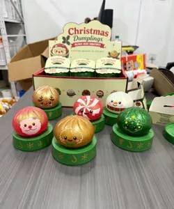 Christmas squishy toy detail, cute festive dumpling blind box set with display stand and figures.