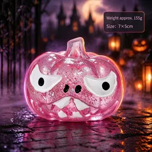 Halloween rosa Glitzer Kürbis Quatschspielzeug Detailansicht mit gruseligem Gesicht im Licht.