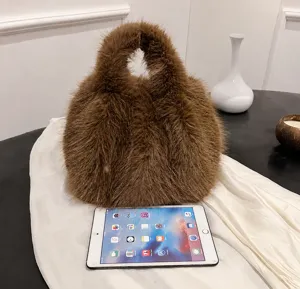 Fluffy plush bucket bag detail view, soft winter handbag with cozy texture and top handle.