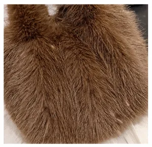 Brown fluffy faux fur handbag detail, soft and cozy plush texture for women winter fashion.