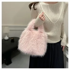 Close-up of the fluffy pink plush handbag, soft texture and cozy winter style details.
