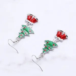 Christmas tree and bell dangle earrings detail, holiday style metal drop earrings.